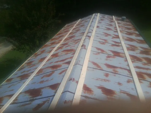 Rusted metal roof panels with new wood purlins before replacement — Storm Damage Roof Repair in Eagle Mountain by Roofing Brothers